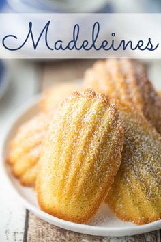 some powdered sugar cookies on a white plate with the words madelines above it