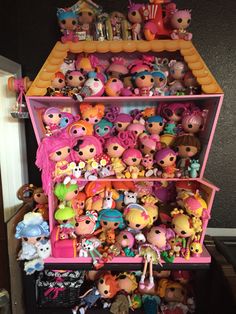 a shelf filled with lots of little doll toys