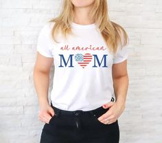 a woman standing in front of a brick wall wearing a white t - shirt that says all american boss