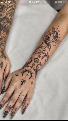 a woman's hand with tattoos on it