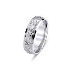 a white gold wedding ring with intricate engraving on the side and an engraved design in the center