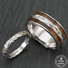 two wedding rings with wood inlays on them