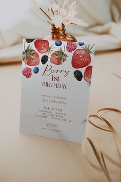 a birthday card with strawberries and berries on it is attached to a tablecloth