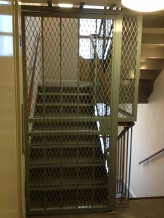 a set of stairs that are next to a metal gate in an office building with no doors