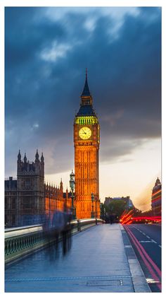 the big ben clock tower towering over the city of london, england at night time