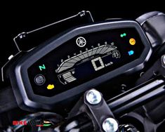 a close up view of the handlebars and gauges on a black motorcycle