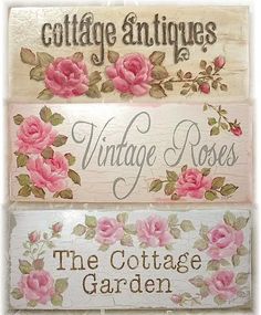 three wooden signs with roses on them and the words cottage antiques written in different languages