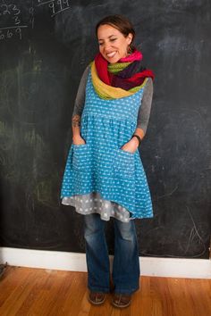 a woman standing in front of a chalk board