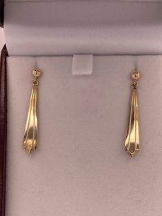 Solid 14kt yellow gold earrings are very elegantly shaped and are a classic look that can be worn daily. Measuring 35mm top to bottom and 5.8mm wide at the widest part (at bottom) and have pierced friction posts. 2.2g. Money back guarantee within 14days. Buyer pays return shipping and must be returned in original condition with box and no alterations. Elegant 14k Gold Linear Earrings With Polished Finish, Classic Yellow Gold Earrings For Formal Occasions, Classic Drop Earrings For Formal Occasions, Formal 14k Yellow Gold Earrings, Classic Formal Drop Linear Earrings, Classic Formal Drop Earrings, Classic Drop Linear Earrings, Classic Long Drop Earrings For Anniversary, Gold Fine Jewelry Linear Earrings For Formal Occasions