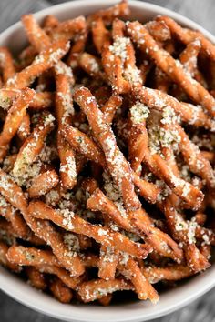 a white bowl filled with sugar covered pretzels