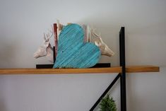 a wooden heart sitting on top of a shelf