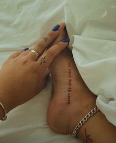 a woman laying in bed with her foot up on the pillow and tattoo reading, i love you to the moon and back