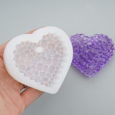 two heart shaped soaps being held by someone's hand