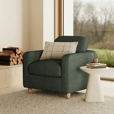 a green chair sitting next to a window in a living room