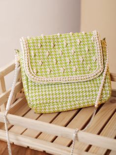 Are you a sling bag collector? Whether you are one or not, we bet you will become one after seeing this green sling bag as well as its simplicity and practicality. The checks' weaving, embellished beads and pearls make it a cutesy pick for a lunch date or a work meeting. Yep, it's THAT versatile. With one compartment and one pocket, this sling bag has been manufactured from printed jacquard fabric and lined with cotton on the inside. The metal fitting and the snap button add a polished look to t Trendy Green Woven Bag, Green Square Woven Bag, Green Woven Crossbody Shoulder Bag, Green Woven Pouch Bag, Green Woven Square Shoulder Bag, Green Woven Shoulder Bag, Green Sling Bag, Shoulder Sling Bag, Crossbody Bags For Travel