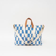 Our new take on Checkers! Our Chambray Checker is our favorite print for our best-selling bag styles. Designed to Carryall. Our mid-size option in our MATATU Collection, the Carryall is your ideal travel companion. Constructed in a sturdy cotton canvas, this bag offers durability, versatility, and reliability. The zip-secure spacious main compartment keeps everything in and features an internal zip compartment for organization along with a quick-access external pocket for on-the-go essentials. F Mother's Day Gift Card, Bag Styles, Spring Bracelet, Clutch Pouch, Mid Size, Backpack Straps, Carry All Bag, Small Wallet, Dog Collars