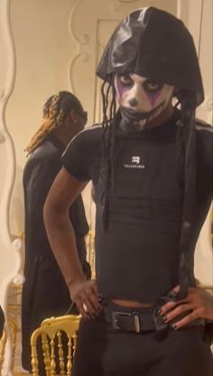 a man with dreadlocks wearing a black outfit