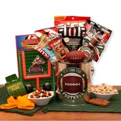 It's Time for football! Send your favorite football fan a real treat. Filled with fanfare to last the entire game and even a game to play during halftime. Every football fan will love the roasted and salted pistachios, the delicious cheddar bacon chips, snack mix and more. The It's Football Time Gift Pail includes: Football pail, Relaxable mini football, It's time for football snack mix, football noise maker, Jack Links Jerky, TGI Fridays cheddar bacon chips, Cliff peanut butter energy bar, Cliff Mojo trail mix bar, referee bottle koozie, sunflower seeds, roasted and salted pistachios, football penalty foul flag, and tabletop football game. Disclaimer: *All contents subject to change based on availability at time of purchase. Any and all substitutions will maintain the monetary value of th Sports Gift Basket, Football Gift Baskets, Bacon Chips, Snack Gift Baskets, Beer Nuts, Pinterest Valentines, Roses Valentine, Football Lover Gifts, Gift Baskets For Him