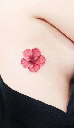 a woman's breast with a flower tattoo on it