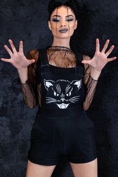 "Black kitty shortalls cuz you are evil and cute. It is soft and warm as your cat and baddy as its soul. The short overalls have side pockets and roomy construction for a comfy fit day and night. ► Material & Washing It's soft, warm, and stretchy. It consists of 80% Polyester, 20% Elastane & feels like Cotton. > Give it a try, and you won't want to take it off. ► Colors The fabric dyes are remarkably vivid, so I must warn you that you will stand out in the crowd! There is no fading or fabric pat Punk Overalls, Black Short Overalls, Dungarees Women, Oversized Overalls, Dungaree Shorts, Overalls For Women, Black Kitty, Short Overalls, Rave Outfit