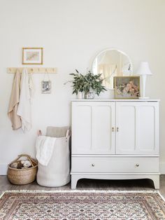 a white cabinet and rug in a room