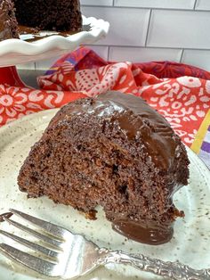 a piece of chocolate cake on a plate with a fork