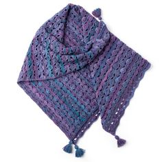 a crocheted shawl with tassels on top is shown in purple and blue