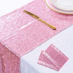 pink sequin table cloth and napkins on a white table