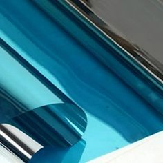 a close up view of the side of a car with blue paint and chrome trim