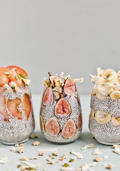 three jars filled with fruit and nuts on top of a white countertop next to each other