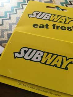 two yellow subway signs sitting on top of a table