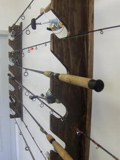 there are many fishing rods hanging on the wall