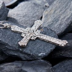 This breathtaking platinum cross shaped pendant features a pierced design with milgrain details and is centered with a round old European cut diamond, weighing 0.28 carats, in a full bezel setting. The center is accented with a total of eighty-eight (88) bead set round cut diamonds. The pendant is topped by a matching bail, bead set with three (3) round single cut diamonds. The pendant measures 71.5mm long, by 46.7mm wide and 4.7mm thick on an 18-inch long, fourteen karat white gold cable link chain, finished with a lobster clasp. Luxury Cross-shaped Diamond Cut Necklace, Classic Diamond Cross Necklace For Formal Occasions, Classic Diamond White Cross Necklace, Classic Diamond Cut Cross Necklace For Formal Occasions, White Gold Crucifix Diamond Necklace For Anniversary, Classic Formal Cross Necklace With Diamond Cut, Formal White Gold Crucifix Diamond Necklace, Classic Diamond Accents Cross Pendant Necklace, Classic Diamond Cut Cross Necklace