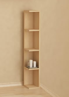 an empty shelf in the corner of a room with candles on it and a candle holder next to it