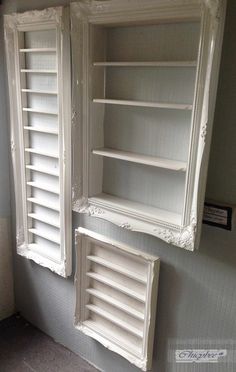 two white shelves with open shutters in a room