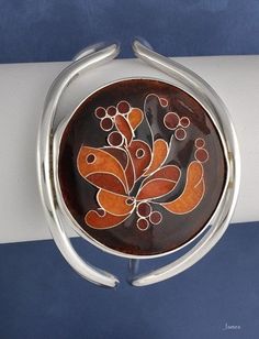 "Sterling silver cuff bracelet with circular cloisonne design for a petite wrist. Cloisonne done with silver wire and enamel. Signed \"Dewey\". Likely an American piece; appears to date to the 1960-1970's. It is not stamped sterling, but we have tested it and guarantee it to be so. Inner circumference (including gap): 7 inches. Please note that the gap is very tiny (about 1 inch), so you will need a petite wrist in order to put this on! Weight: 45.3 grams; 1.58 ounces." Unique Nickel-free Cuff Bracelet, Unique Nickel-free Round Cuff Bracelet, Black Enamel Bracelets As Gift, Sterling Silver Collectible Bangle, Unique Round Metal Cuff Bracelet, Adjustable Enamel Bangle As Gift, Adjustable Enamel Cuff Bracelet As Gift, Adjustable Enamel Bangle For Gift, Adjustable Round Enamel Bracelets