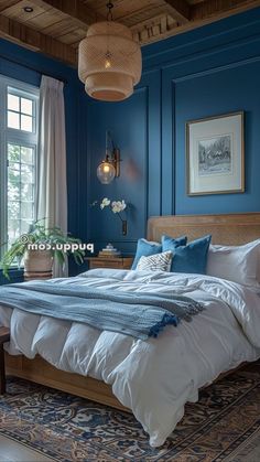 a bedroom with blue walls and white bedding