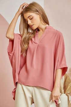 This casual oversized blouse comes with a split neckline and voluminous dolman sleeves for a relaxed but chic look. The ruffled detailing at the back gives it a little extra flair and femininity while still being easy to pair with your favorite jeans. Simply throw it on for a effortlessly stylish weekend ensemble that's perfect for coffee dates or running weekend errands. 100% Rayon Flowy V-neck Top For Work, Chic V-neck Tunic For Spring, Trendy Oversized V-neck Blouse, Chic Solid Color Split Neck Blouse, Chic Solid Split Neck Blouse, Versatile Oversized Solid Color Top, Versatile Spring Blouse In Solid Color, Versatile Blouse For Spring, Chic V-neck Blouse With Relaxed Fit