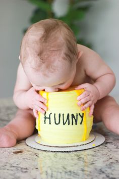 a baby sitting in front of a cake with the words funny on it