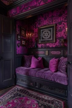 a purple couch in front of a black door and pink wallpaper on the walls