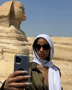 a woman taking a selfie in front of the great sphinx