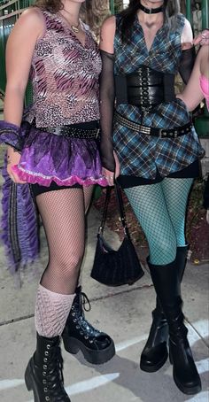 two women dressed in costumes standing next to each other