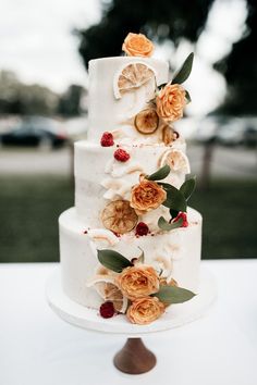 a three tiered white cake with flowers on it