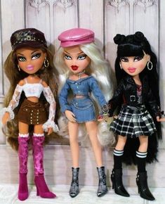 three dolls are standing next to each other