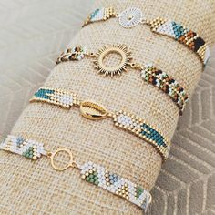 a stack of bracelets sitting on top of a piece of burlied fabric