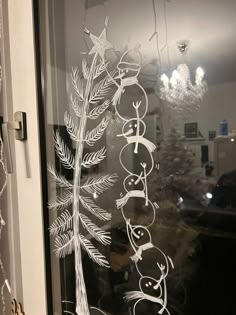 a frosted glass window with an image of a christmas tree on the front door