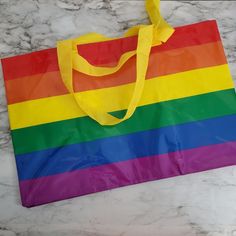 a rainbow colored bag sitting on top of a marble counter