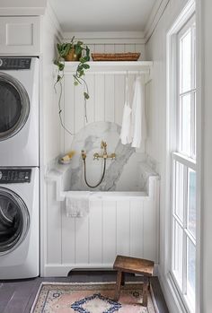 an instagramted photo of a washer and dryer in a room with white walls