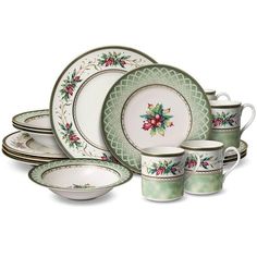 a set of christmas dinnerware with holly decorations