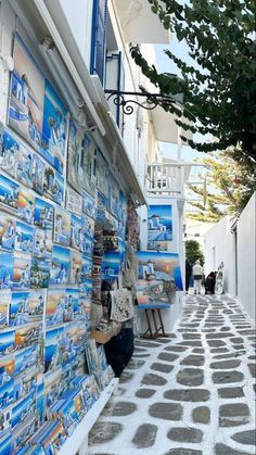 an alley way with many pictures on the wall